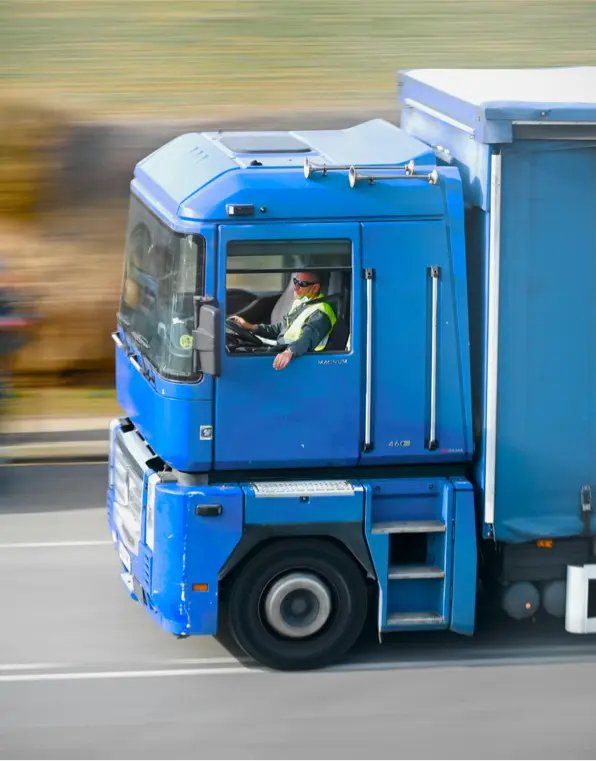 man driving a blue delivery truck