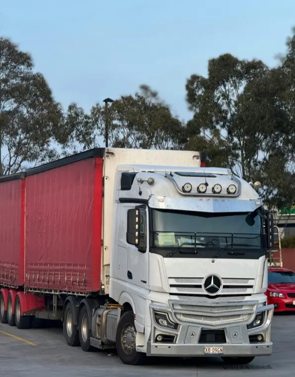 a parked red and white delivery truck